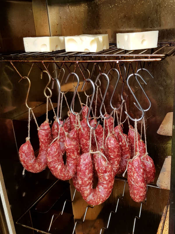 Die Knackwürste werden in den Räucherschrank gehangen.